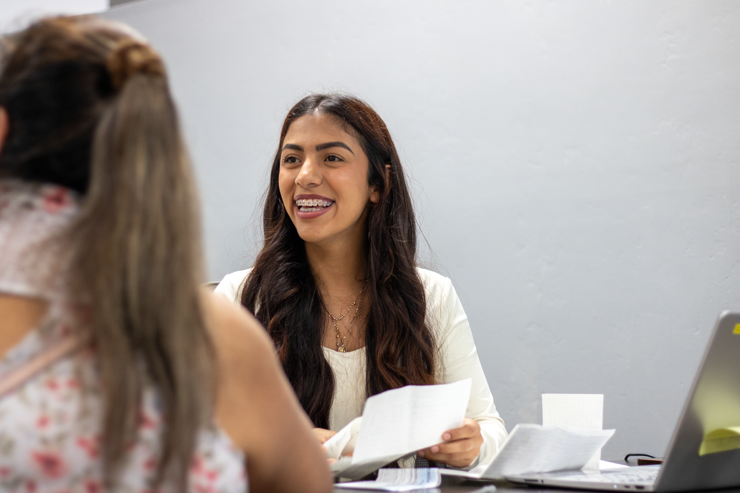 Two women are seated at a table.