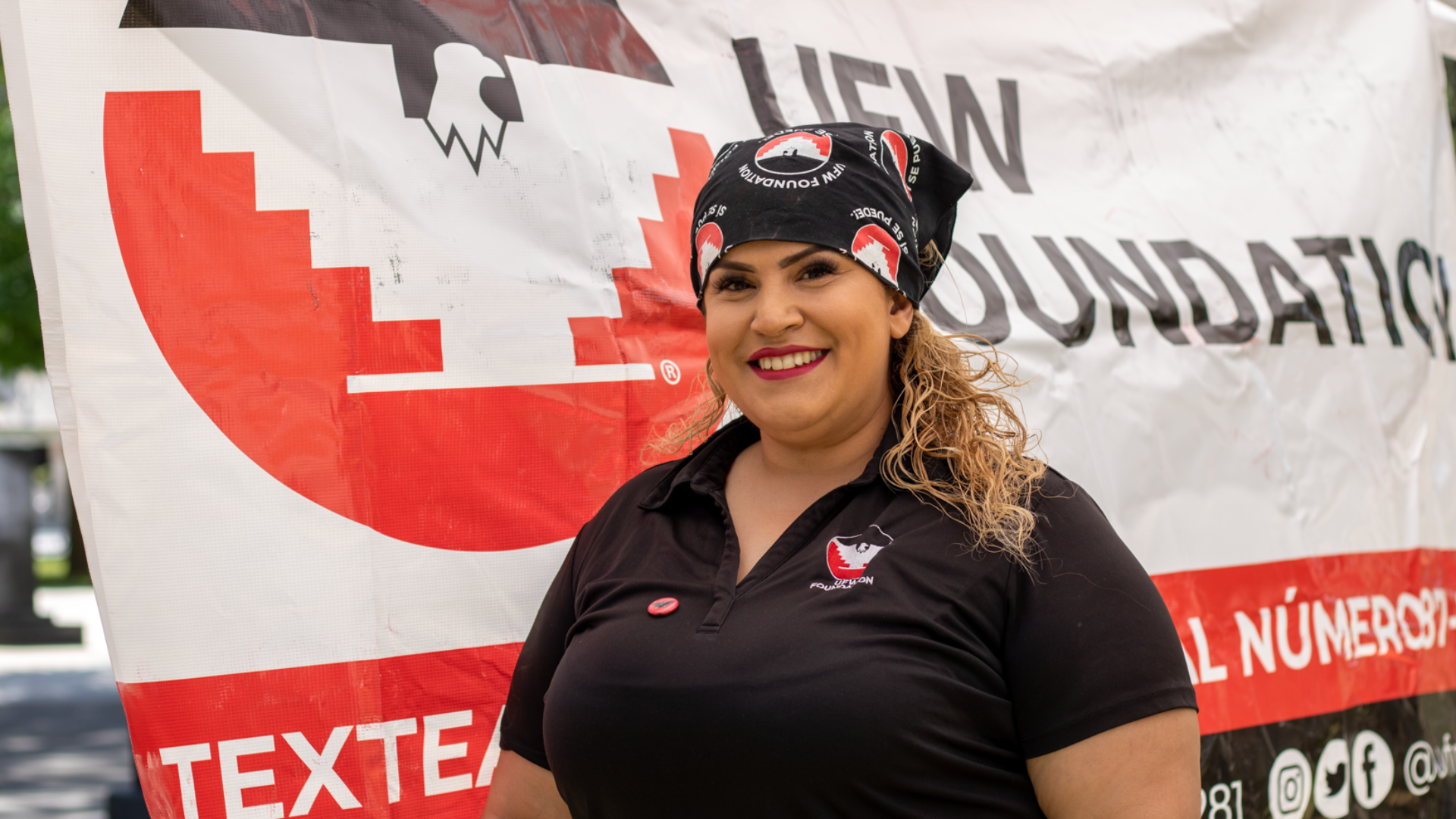 A woman, Linda Duran, is standing in front of a large UFW Foundation banner.