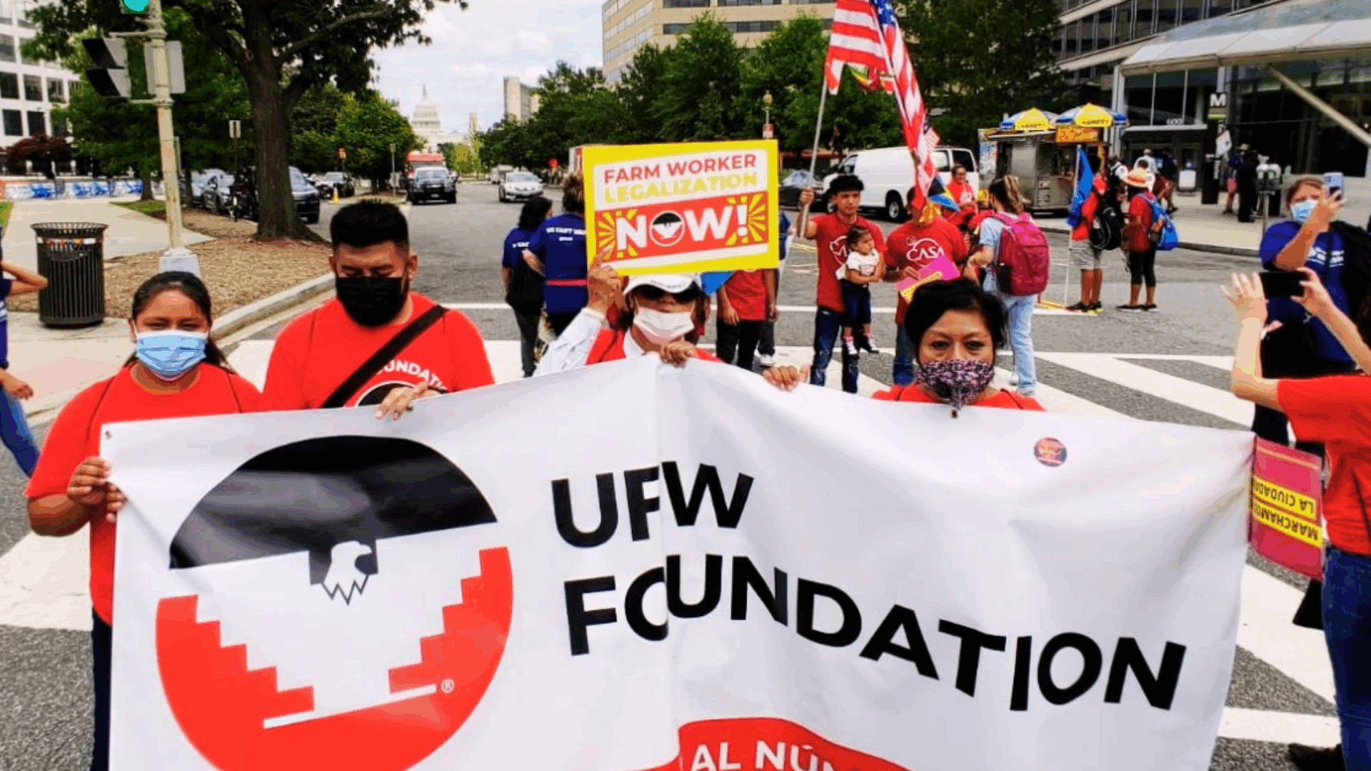 Several individuals stand together, displaying a banner that says "UFW Foundation" during a rally.