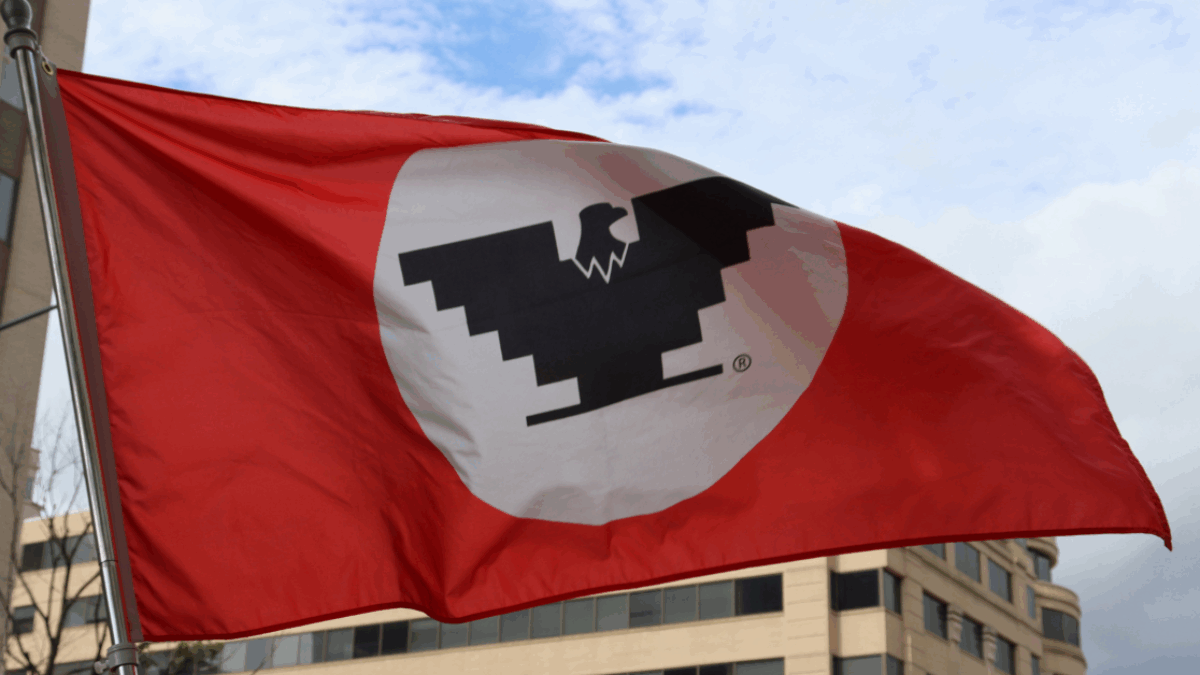 A red and white flag featuring a prominent black eagle in the center.